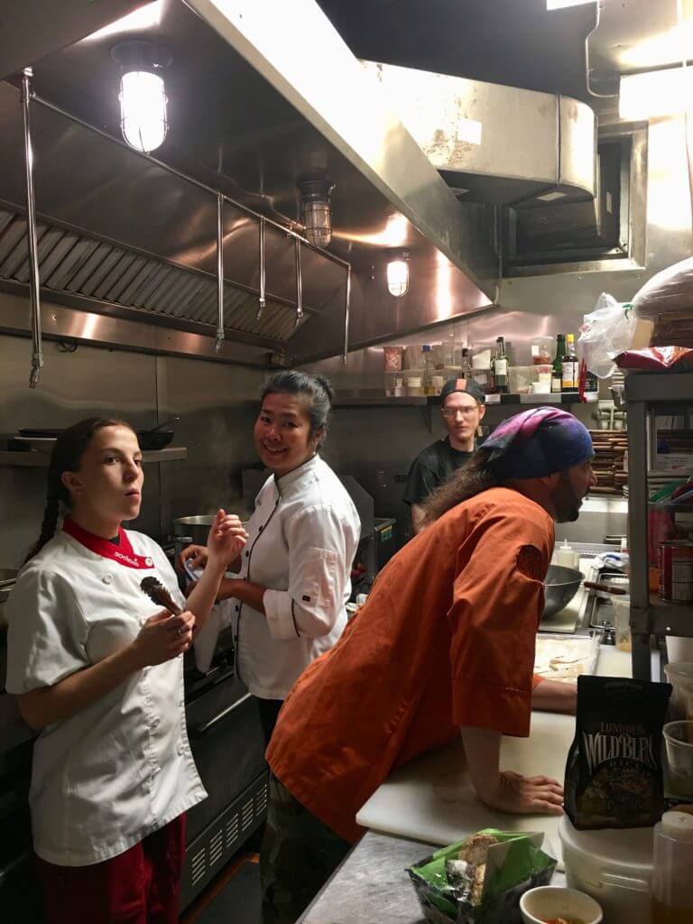 Clowning in the kitchen, from left: Ana Couch, Supansa Banker, unknown cook, and Whistle Pig sommelier Charles Wear (in orange).